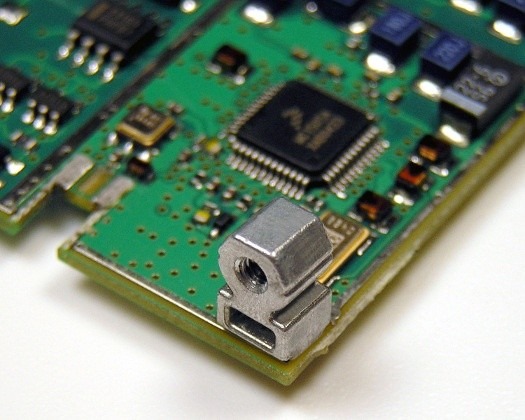 Installed surface-mount right-angle fastener on a board.
