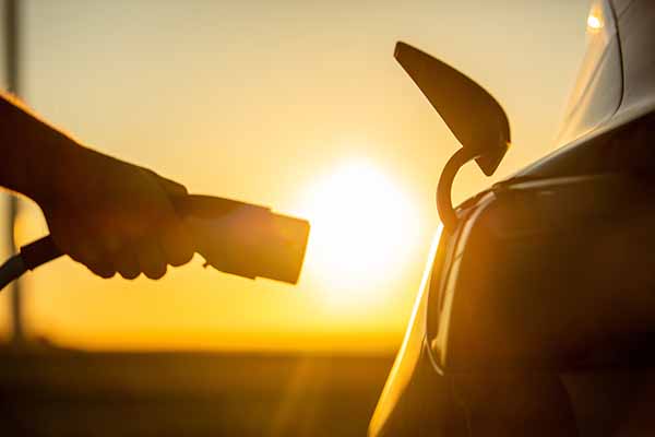 Car charging at sunrise